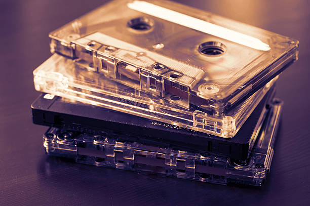 Stack of old audio tapes on a dark wooden background