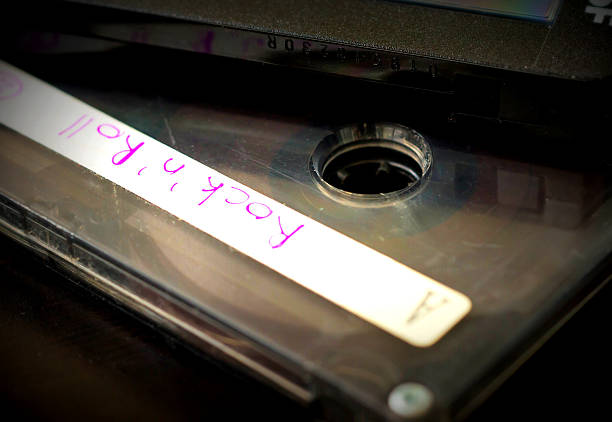 Old audio cassette on a dark wooden background close up