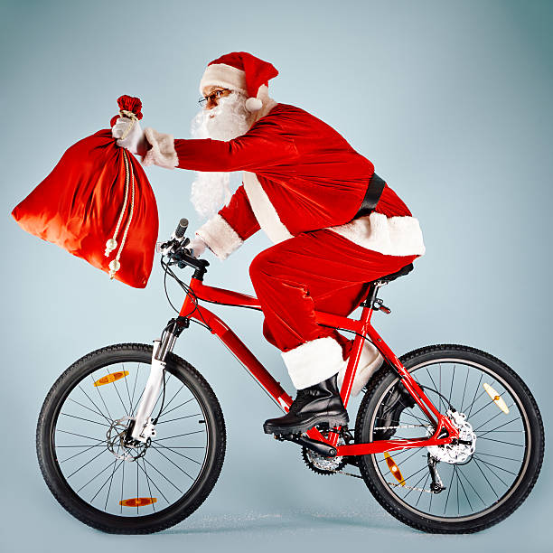 istock Santa with red sack on bicycle 490514496