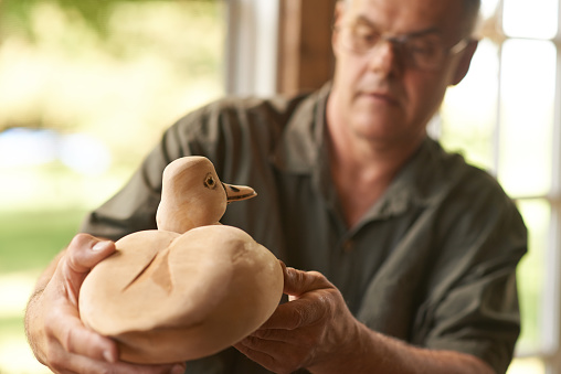Shot of a man working on a woodcarving of a duckhttp://195.154.178.81/DATA/i_collage/pu/shoots/805641.jpg