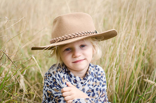 istock girl with hat in autumn meadow 490517290