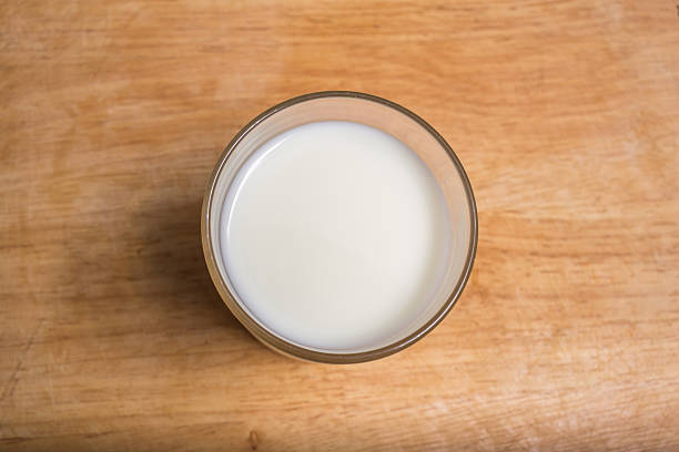 istock Fresh milk placed on a wooden table, top view 490517398