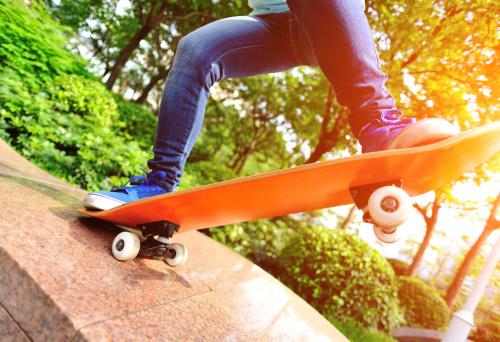 skateboarding  woman jump on ramp in skateboard park