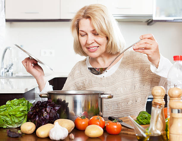 istock woman with ladle cooking soup in pan 490523277