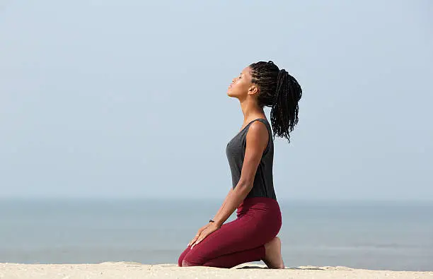 Photo of Woman meditating at the beach