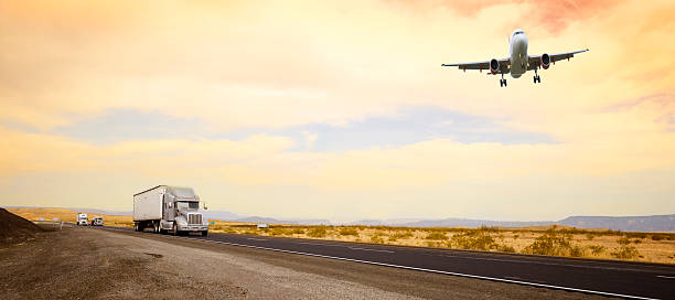 Trucks on the road and airplane, California