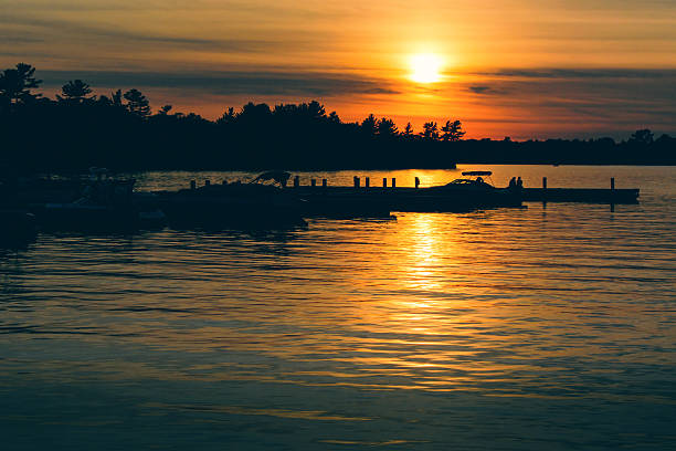 istock Sun Setting Over Lake with Boats Docked on the Water 490524683