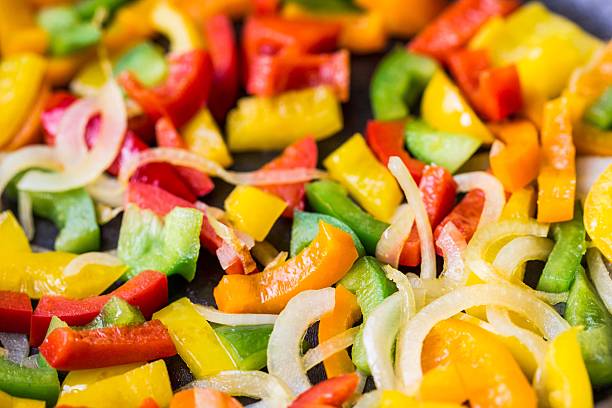 Mixed colorful peppers paprica fried in pan stock photo