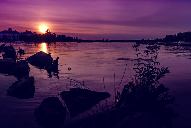 Photo of a summer sunset over  Muskoka Bay, Gravenhurst, Ontario, Canada.  Horizontal orientation.