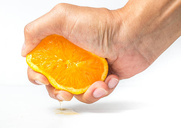 istock Hands are squeezed orange on a white background 490541866