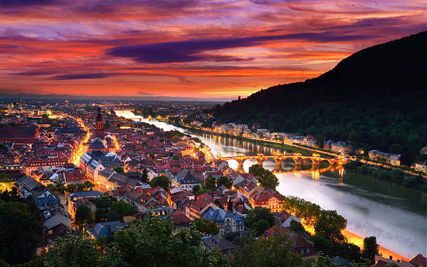 Heidelberg, Germany, with dramatic dusk sky Heidelberg, Germany, aerial view at dusk, with dramatic sunset sky and the lights of the city, Neckar river and the Old Bridge heidelberg germany photos stock pictures, royalty-free photos & images