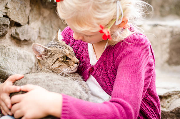 istock friendship of child and cat 490545336