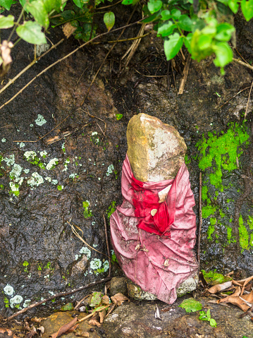 Rock wrapped in cloth and painted along trekking path on slopes of Knuckles range not far from Kandy, west Sri Lanka. It is signified praying place for number of Buddhist visitors which past by this area.