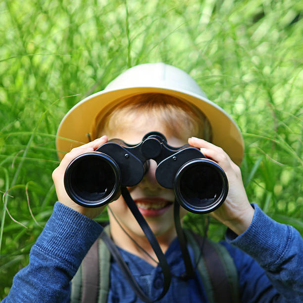 istock Child in Safari Hat Looking Through Binoculars Outdoors 490545840