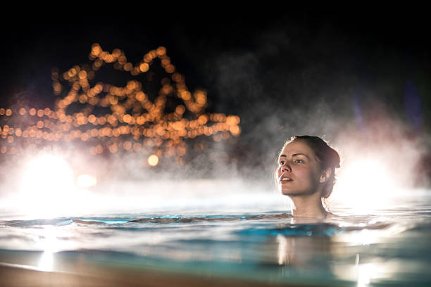 istock Woman spending a winter night in a heated swimming pool. 490547014