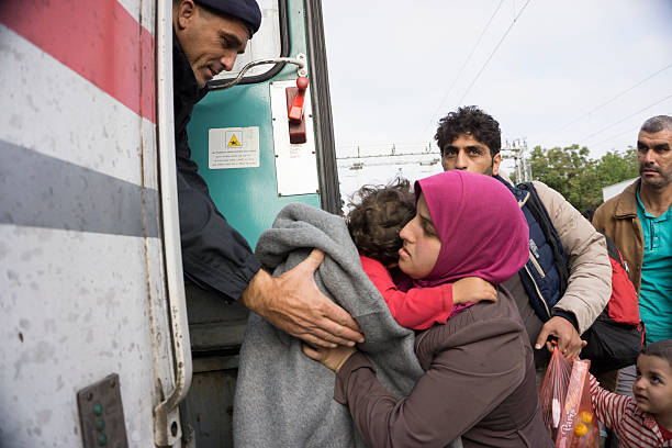 Syrian refugees Tovarnik, Сroatia - September 24, 2015: Syrian refugees enter the train at the railway station in Tovarnik Croatia, which is very close to the Serbo Croatian border. Many refugees are crossing Croatia from Syria,Pakistan Afghanistan going to other countries of Europe as Germany,Austria,Denmark and others searching for better future for their families. Nobody wants to be refugee and no one of this people coming from this countries want to be, but they are running away to not be killed in any moment in Syria or Afghanistan. refugee camp stock pictures, royalty-free photos & images