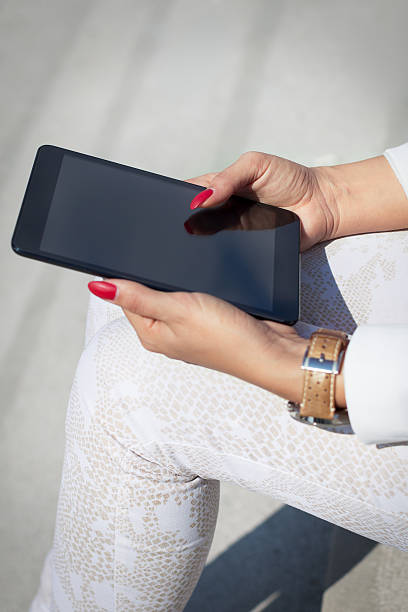 istock Businesswoman reading latest news on tablet 490547310