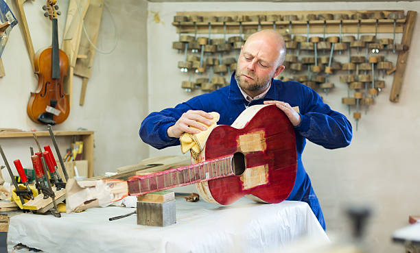 istock Craftsman holding unfinished guitar 490547444