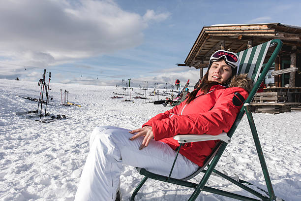 istock Smiling woman sunbathing in deck chair on a mountain. 490547946