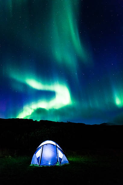 istock Illuminated tent and aurora in Iceland 490550218