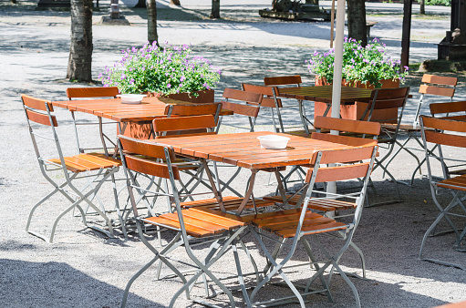 Table and chairs outside a restaurant. Beer garden awaits its guests