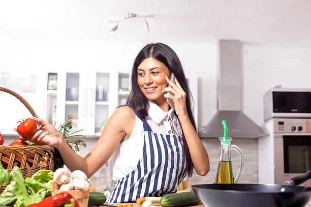 istock Young  woman in kitchen and talking 490553336