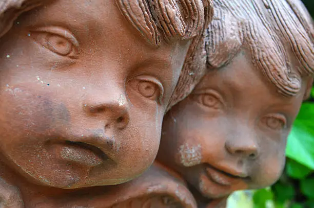 Photo of Close up of two antique clay angel figurines