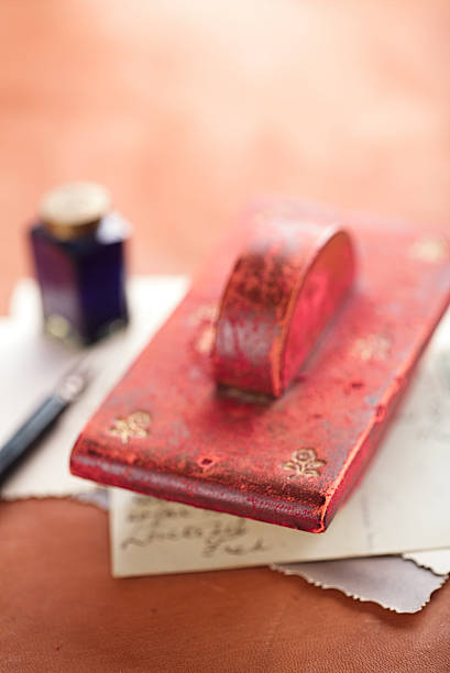 vintage red leather ink blotter  with retro post cards vintage red leather ink blotter  with retro post cards on leather table, shallow dof inkpen stock pictures, royalty-free photos & images