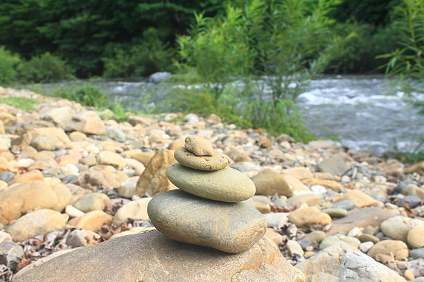 istock Stones pyramid near small river symbolizing zen 490555891