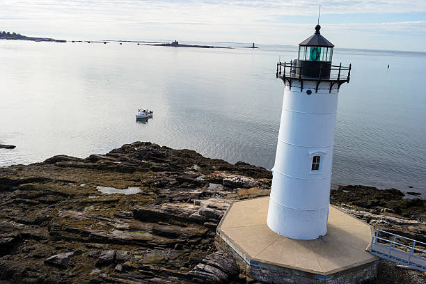 Portsmouth Harbor Lighthouse Portsmouth harbor lighthouse with boat, river and Atlantic ocean by Bird's Eye Photography, LLC. portsmouth nh stock pictures, royalty-free photos & images
