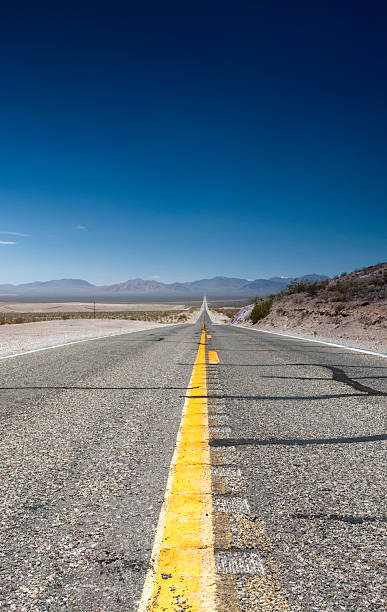 istock Long Highway Under the Summer Sun Across Death Valley 490556428