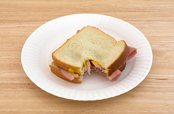 istock Honey ham sandwich on a paper plate bitten 490556950