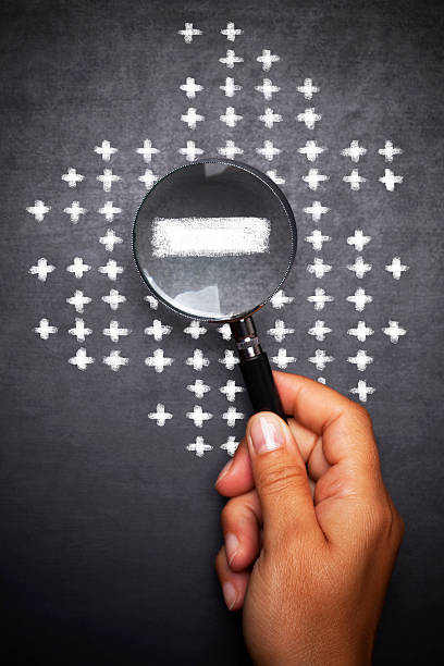 istock Magnifying glass searching Minus sign between  Plus  signs 490557154