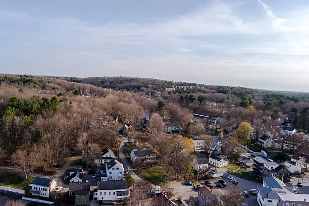 Aerial of the rolling hills and neighborhoods of Newmarket, NH on a spring afternoon.