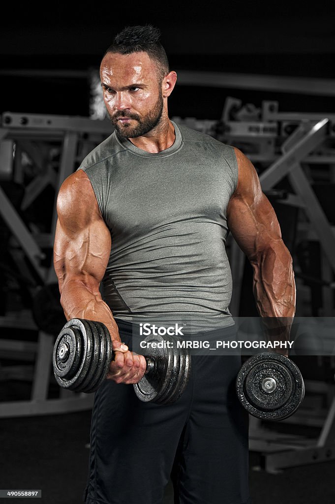 Body Building In Progress Strong Muscular Men exercise With Weights in the Gym Active Lifestyle Stock Photo
