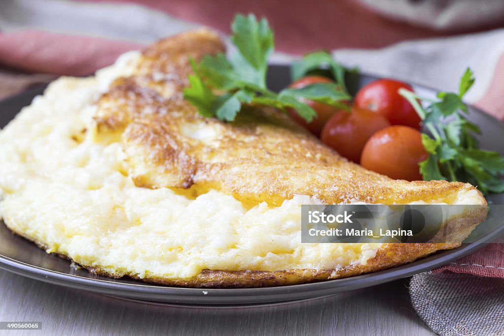Rolled airy light french omelet with tomato Appetizer Stock Photo
