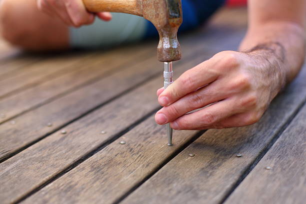 Nail Punch Using a nail punch on a patio. boat deck stock pictures, royalty-free photos & images