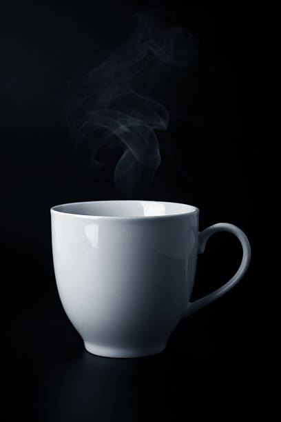 istock white cup with hot liquid and steam on black 490575211