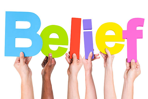 istock Multiethnic Group of Hands Holding Word Belief 490575245
