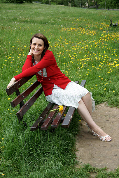 Woman sitting on bench stock photo