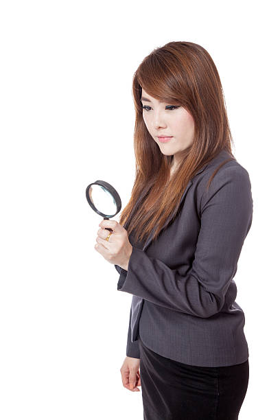 istock Asian businesswoman use magnifying glass looking down 490577479