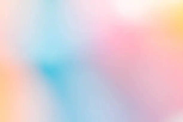 Photo of blurred pastel coloured background of blues and pinks and yellows