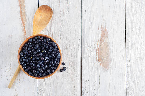istock Wooden bowl with forest blueberry 490579346