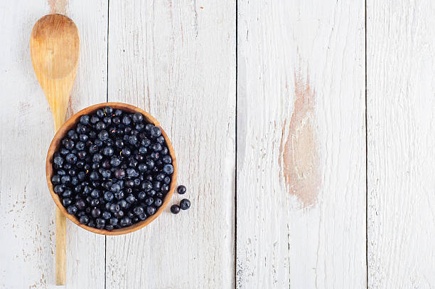 istock Wooden bowl with forest blueberry 490579400