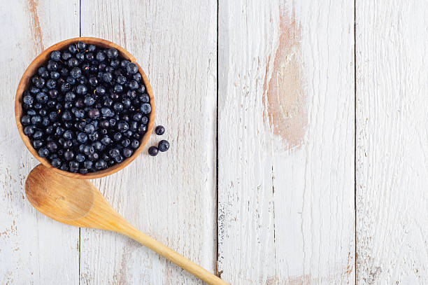 istock Wooden bowl with forest blueberry 490579452