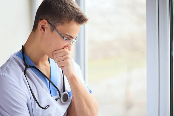 Young doctor thinking stock photo