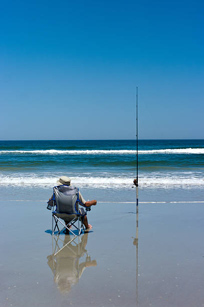 Fishing on the Beach stock photo