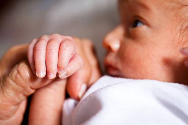 istock Newborn Holding Mother's Hand 490580719