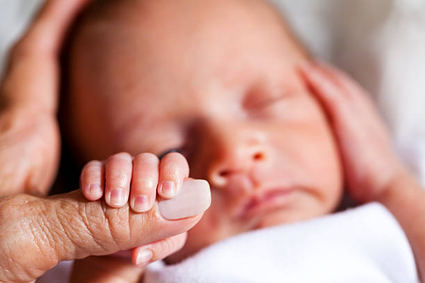 Newborn Holding Mother's Hand
