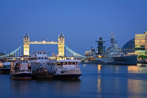 Tower bridge and HMS Belfast at dusk, London.